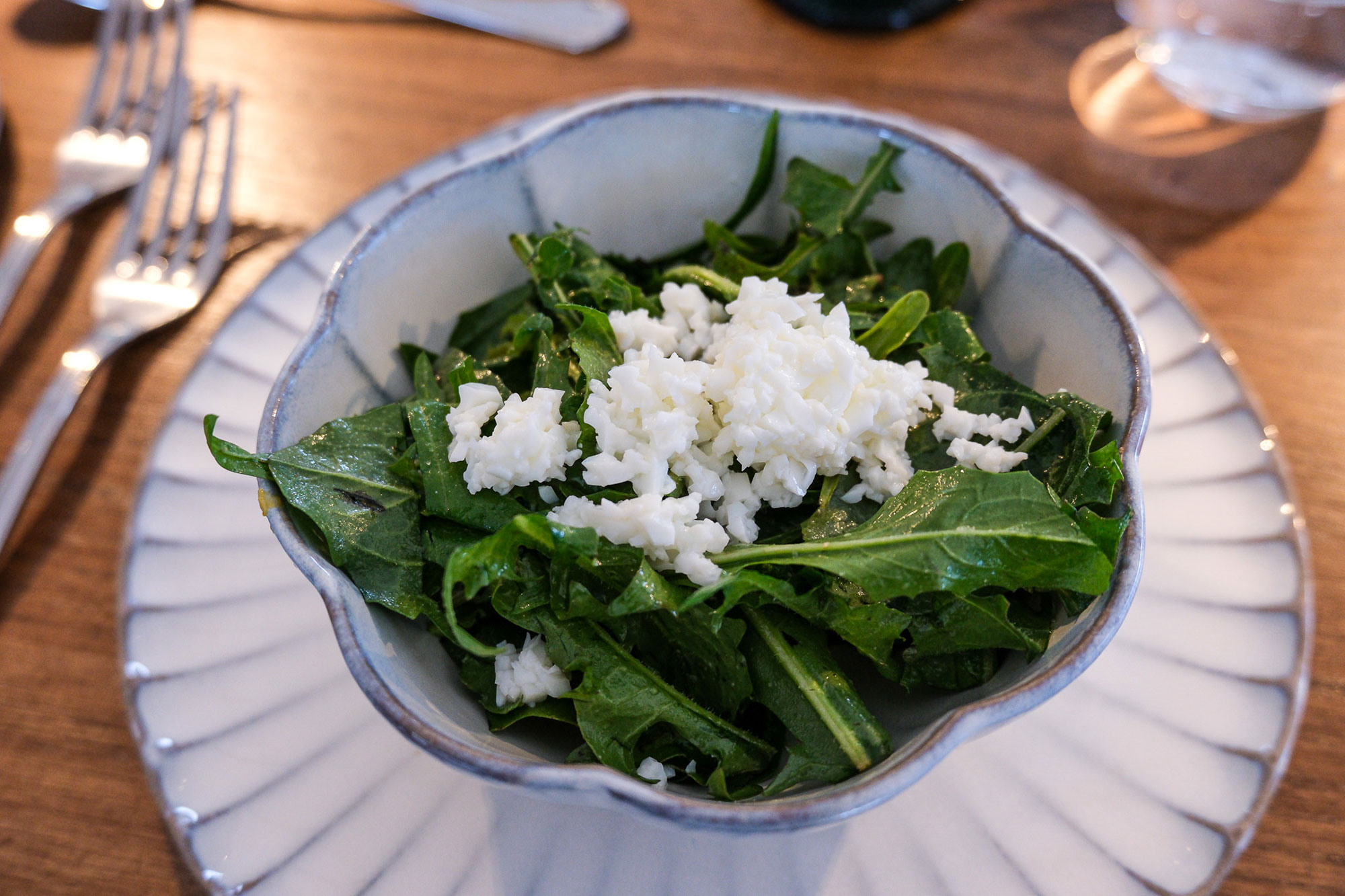 Rustikale Schüssel mit frischem Rucola-Salat und gebrösteltem Weißkäse beim Tavolata-Abend der Pension Leuchtenburg