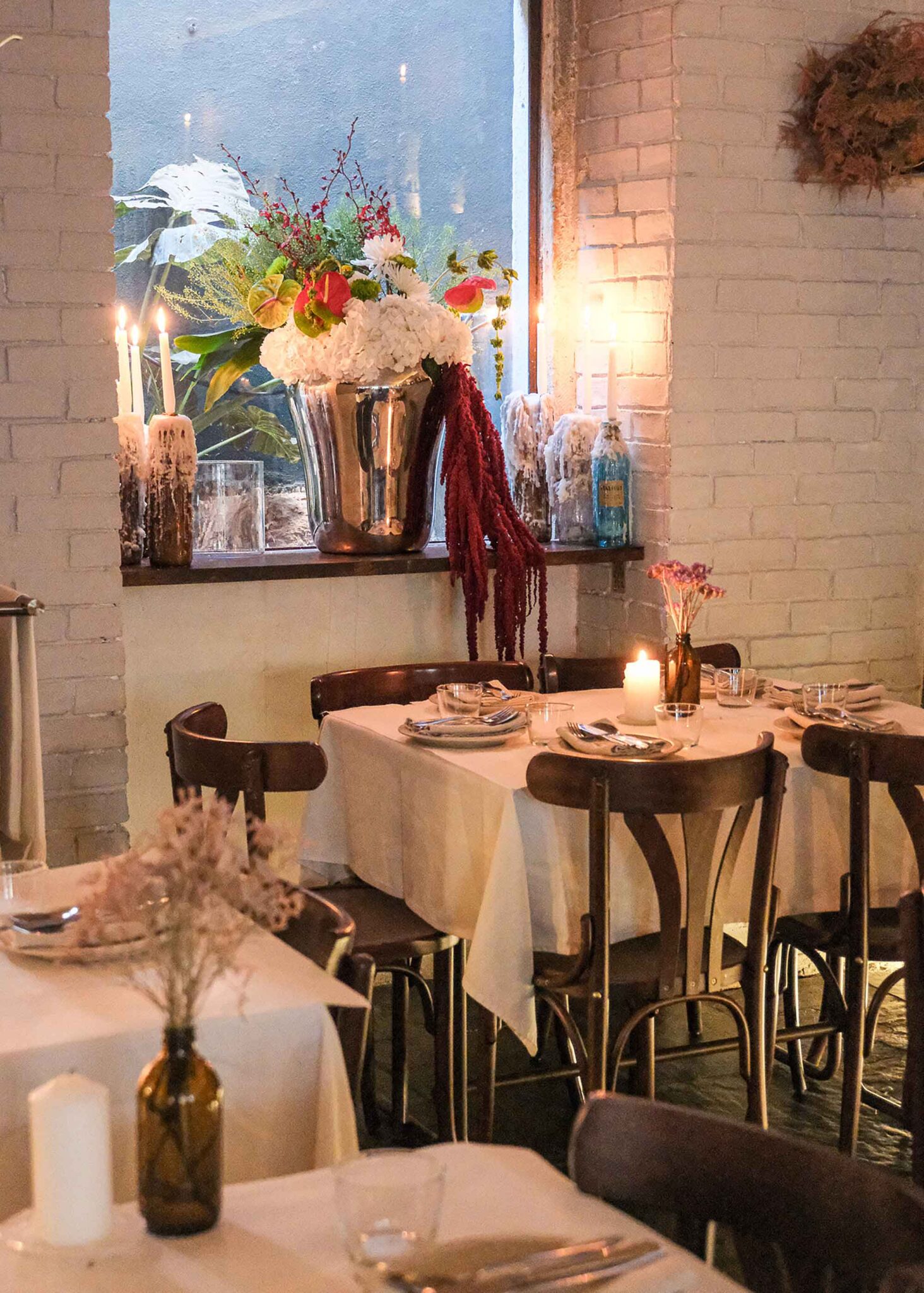 Stimmungsvoll gedeckter Tisch mit Kerzen und Blumen im Restaurant Prado in Lissabon
